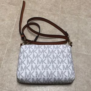 White and brown Michael Kors cross body purse.